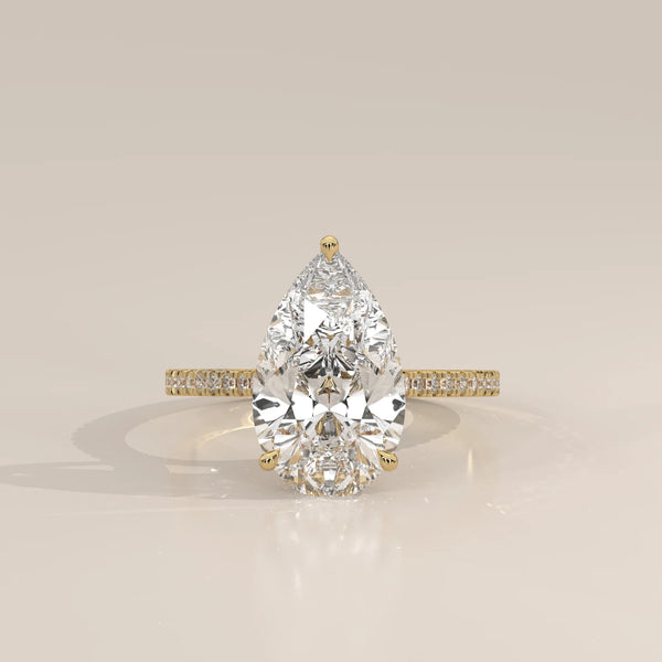 Cygri 5 Carat Pear Lab Grown Diamond Ring, Hidden Halo Pave Band in yellow gold, photographed head-on.