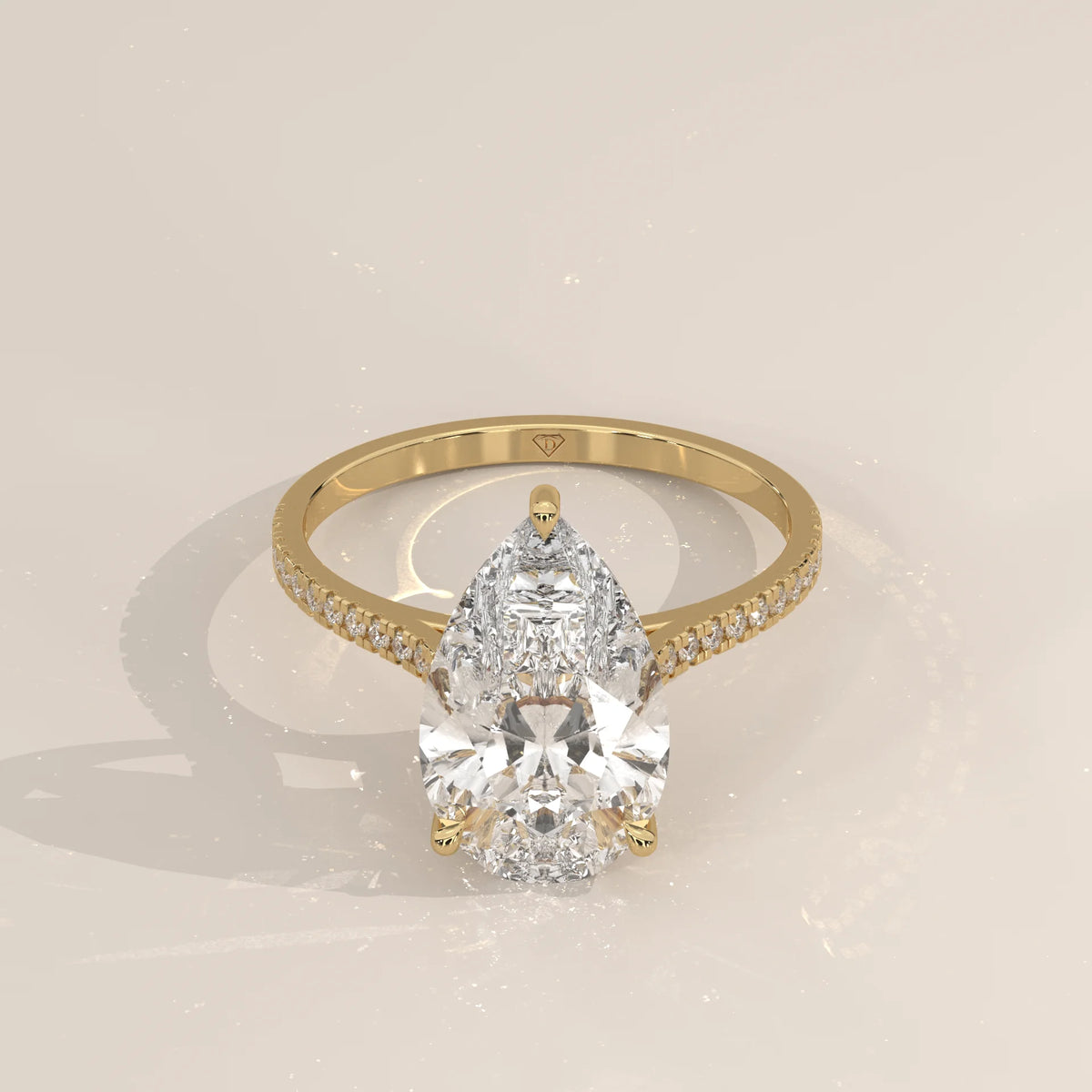 Cygri 5 Carat Pear Lab Grown Diamond Ring, Hidden Halo Pave Band in yellow gold, shown from the front.