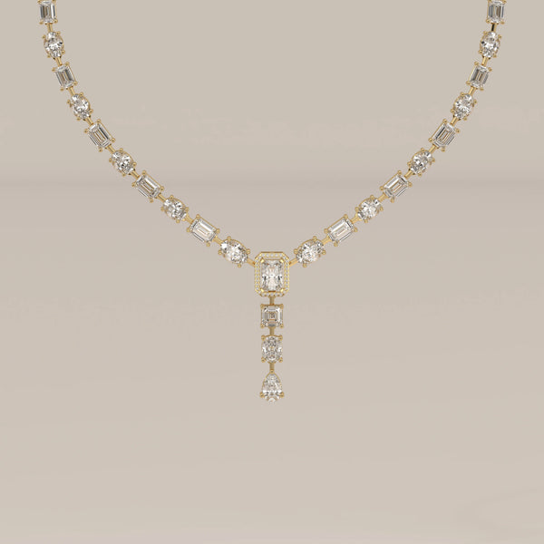 An emerald cut halo y-drop lab grown diamond necklace in yellow gold, shown from the front.
