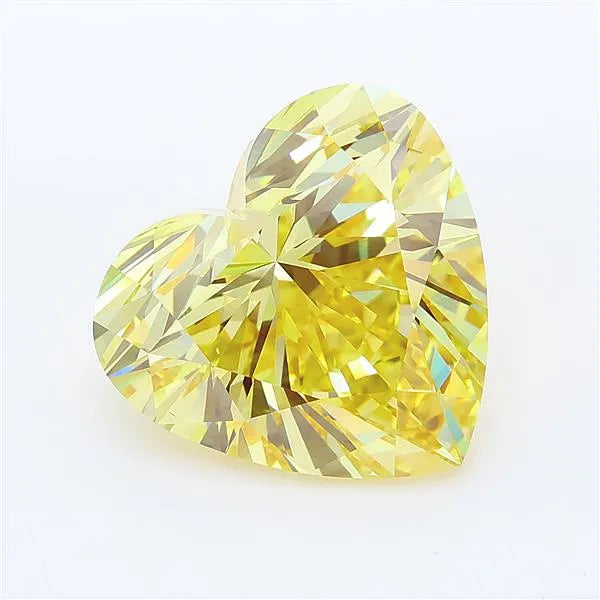 Heart cut intense yellow lab grown diamond with brilliant facets on a white background.