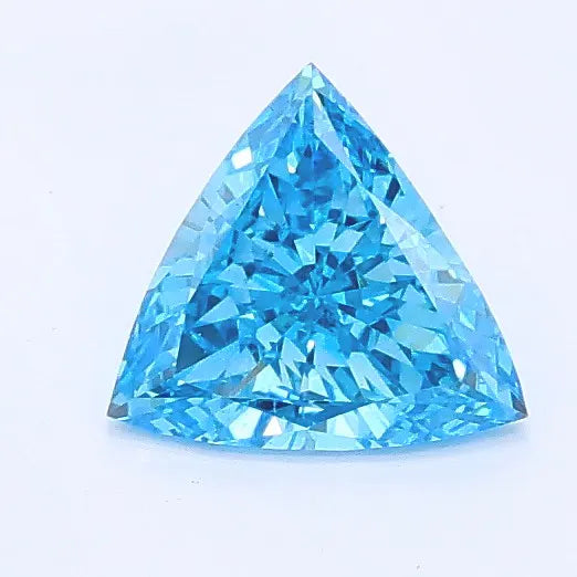 Triangular brilliant cut blue lab grown diamond with faceted surface and vibrant blue color.