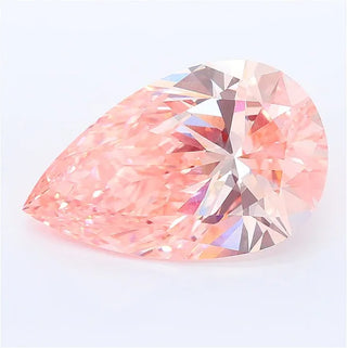 Pear cut vivid pink lab grown diamond with brilliant facets on a white background.