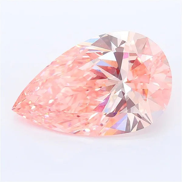 Pear cut vivid pink lab grown diamond with brilliant facets on a white background.