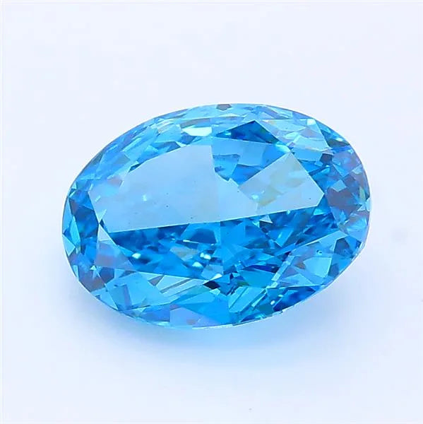 Oval cut vivid blue lab grown diamond with brilliant facets on a white background.