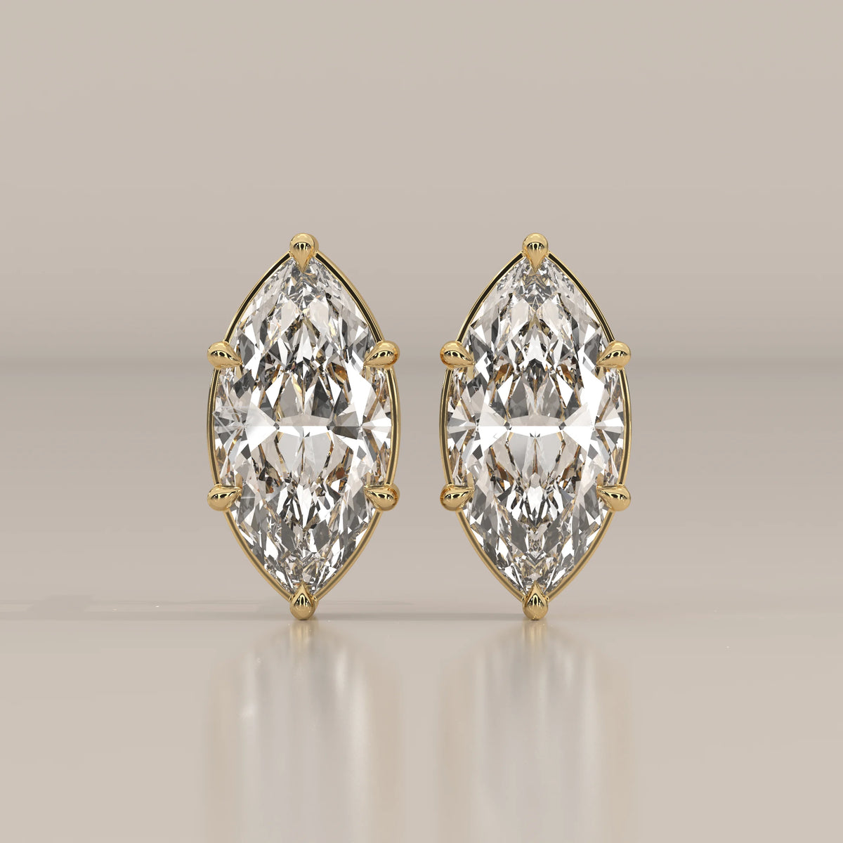 Pair of marquise-cut diamond stud earrings in yellow gold.
