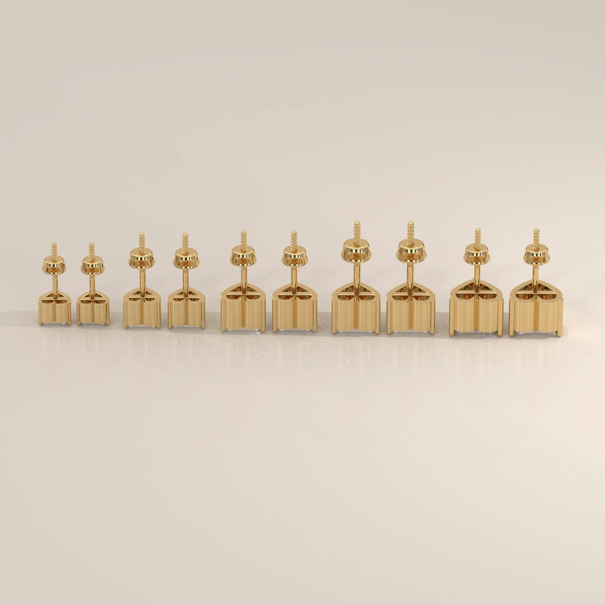 Row of gold earring settings in ascending size.