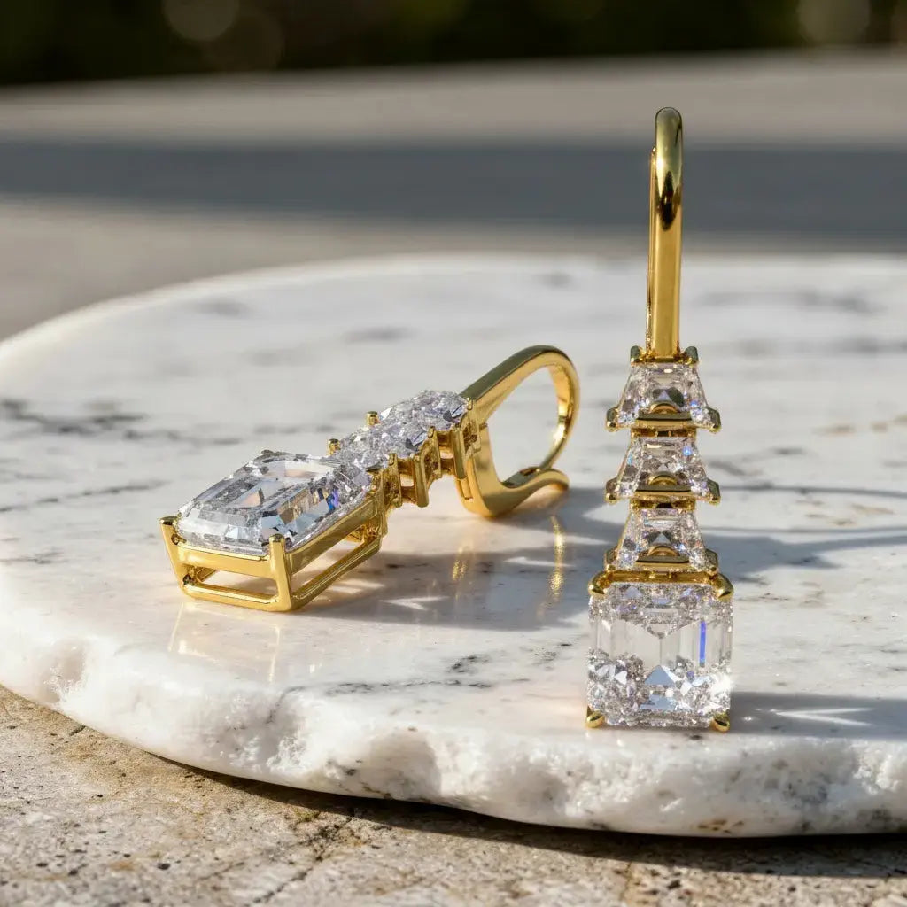 Flat-Lay: Emerald Cut Diamond Earrings with Prong Setting in 14k Yellow Gold - Lab Grown - Driona Jewels