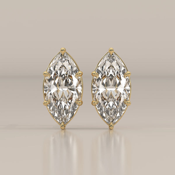 A pair of elegant 14k gold earrings featuring large marquise-cut diamonds.