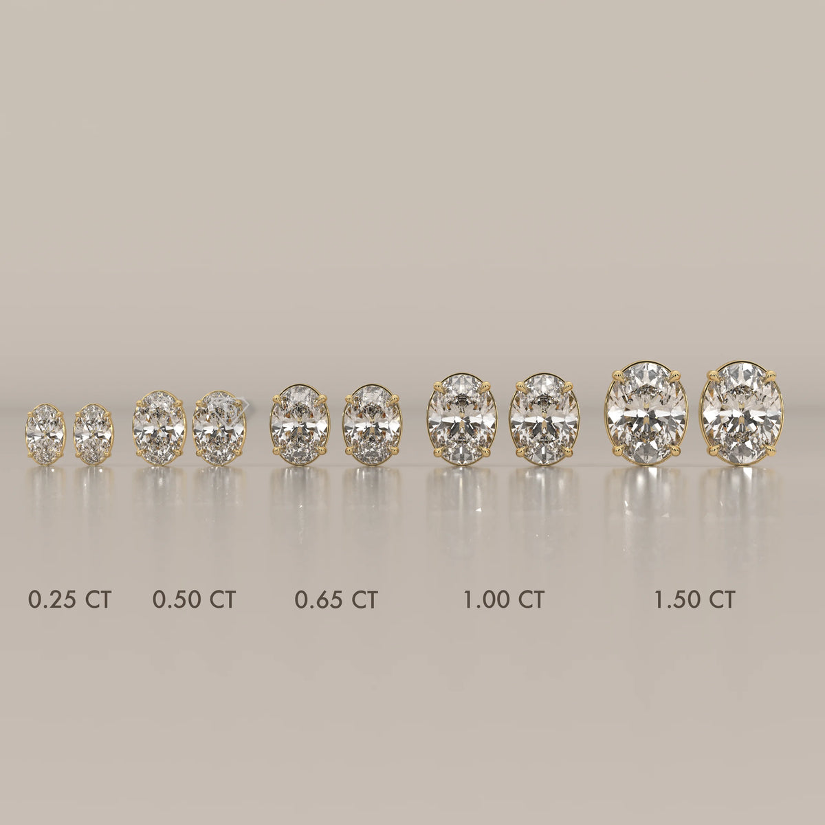 Collection of oval cut diamond earrings in yellow gold, displayed from smallest to largest.