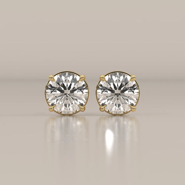 Pair of classic gold stud earrings with round cut diamonds.