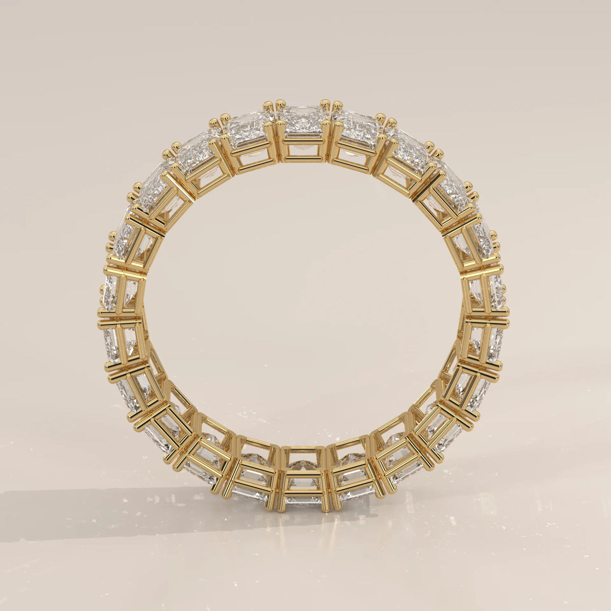 East West Emerald Cut Diamond Eternity Band in Solid Gold in yellow gold, photographed head-on.