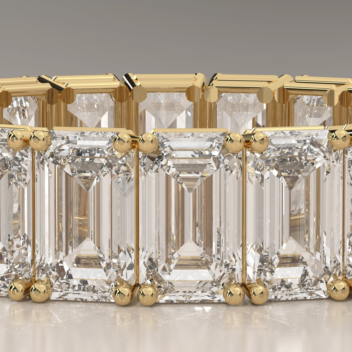 East West Emerald Cut Diamond Eternity Band in Solid Gold in yellow gold, front view on a plain background.