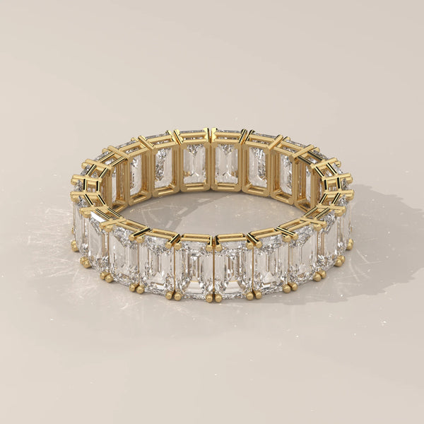 East West Emerald Cut Diamond Eternity Band in Solid Gold in yellow gold, shown on a plain background.