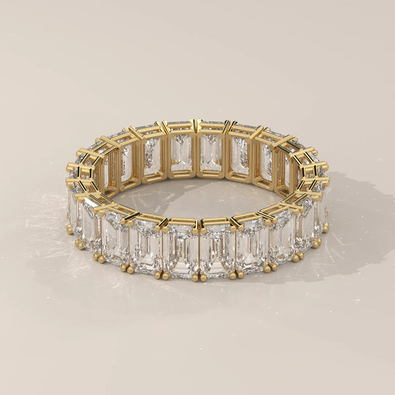 East West Emerald Cut Diamond Eternity Band in Solid Gold in yellow gold, shown on a plain background.