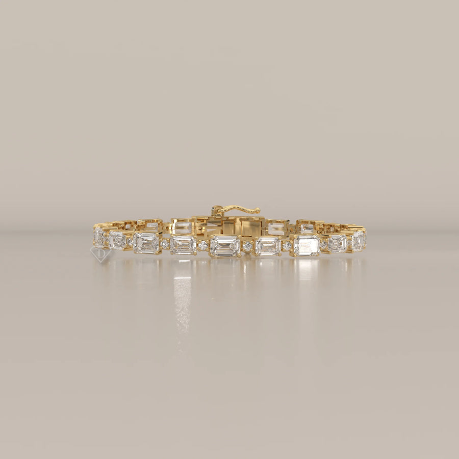East West Emerald Cut Lab Grown Diamond Bracelet with Round Accents in yellow gold, shown from the front.