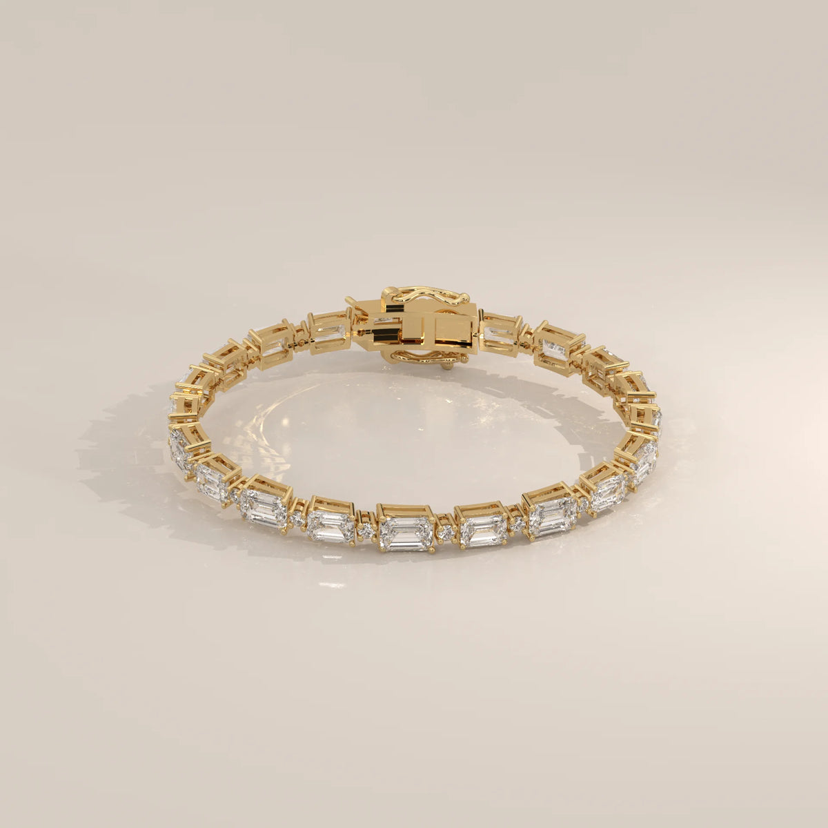 East West Emerald Cut Lab Grown Diamond Bracelet with Round Accents in yellow gold, shown from the side.