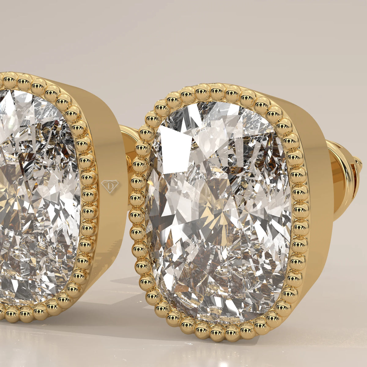 Elongated Cushion Lab Grown Diamond Studs in a Milgrain Bezel in yellow gold, photographed at a three-quarter angle.