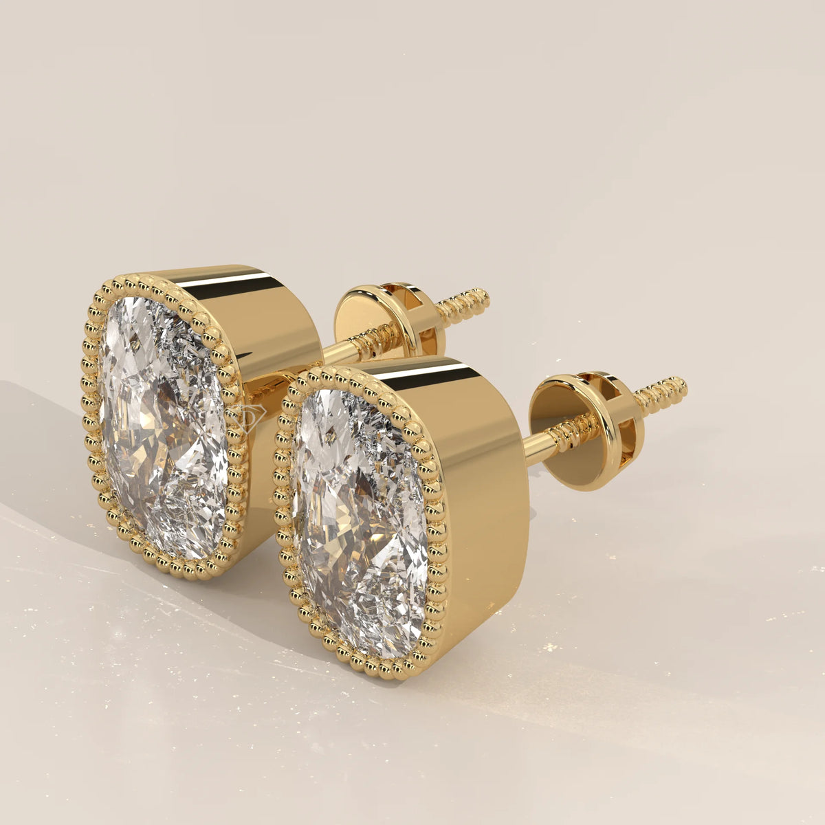 Elongated Cushion Lab Grown Diamond Studs in a Milgrain Bezel in yellow gold, shown at an angle.