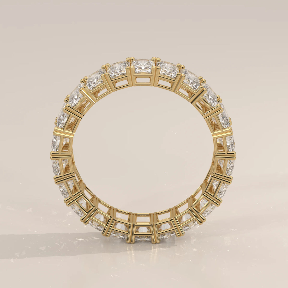 Elongated Radiant Cut Diamond Eternity Band Set East West in yellow gold, photographed at a three-quarter angle.
