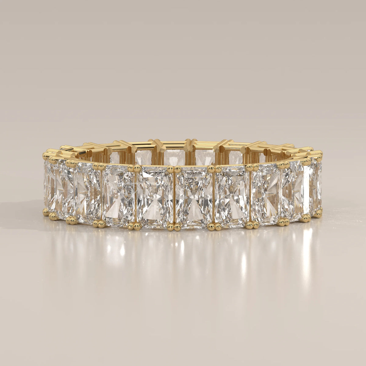 Elongated Radiant Cut Diamond Eternity Band Set East West in yellow gold, shown from the front.