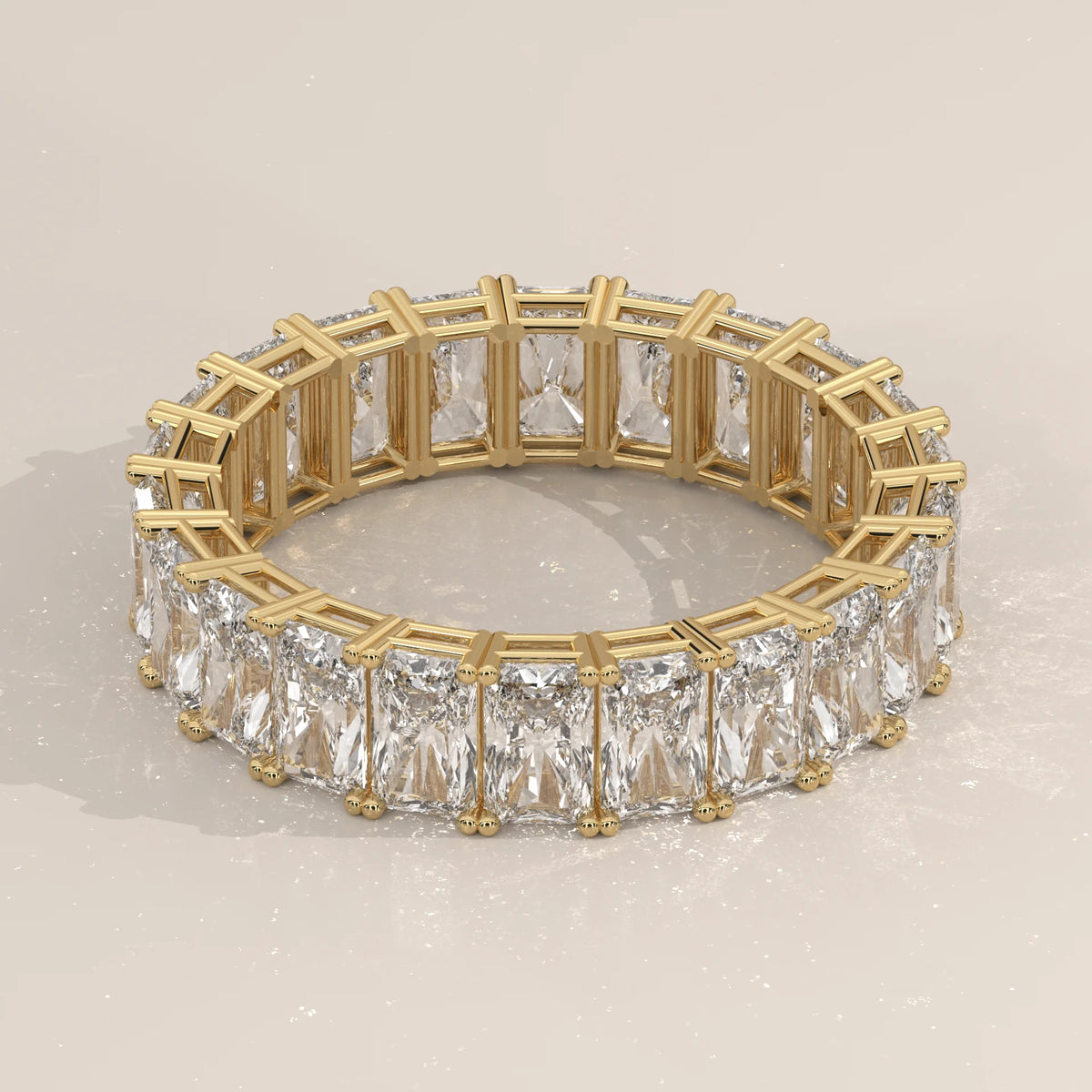 Elongated Radiant Cut Diamond Eternity Band Set East West in yellow gold, shown on a plain background.
