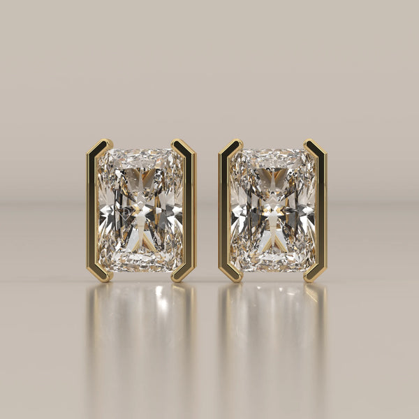 Elongated Radiant Half Bezel Lab Grown Diamond Stud Earrings in yellow gold, shown from the front.