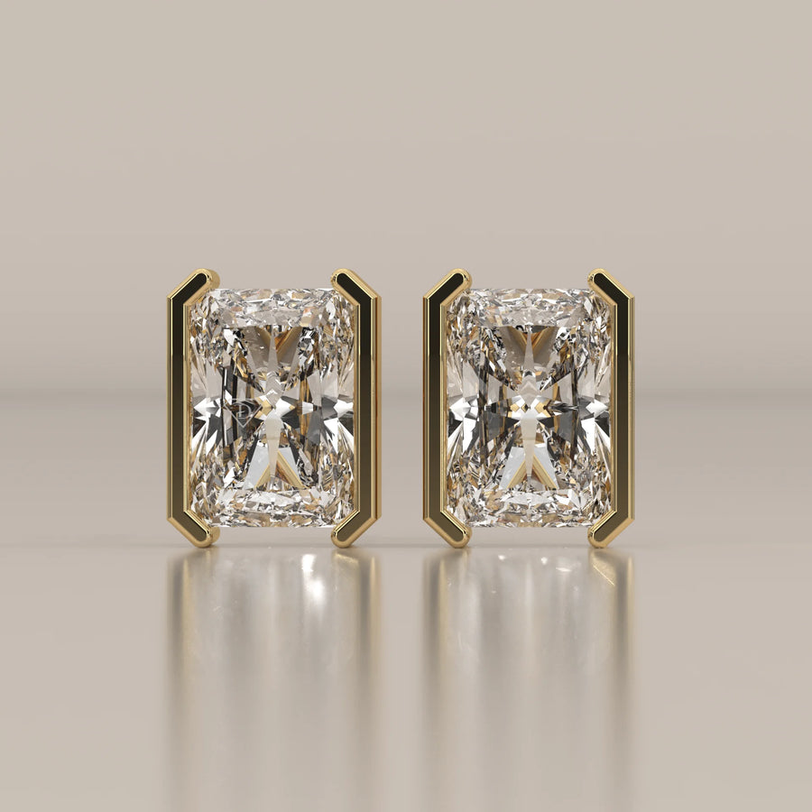 Elongated Radiant Half Bezel Lab Grown Diamond Stud Earrings in yellow gold, shown from the front.