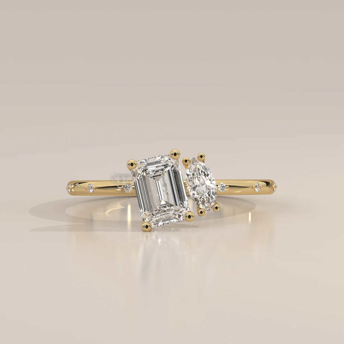 Yellow gold ring with an emerald-cut and a marquise-cut diamond.