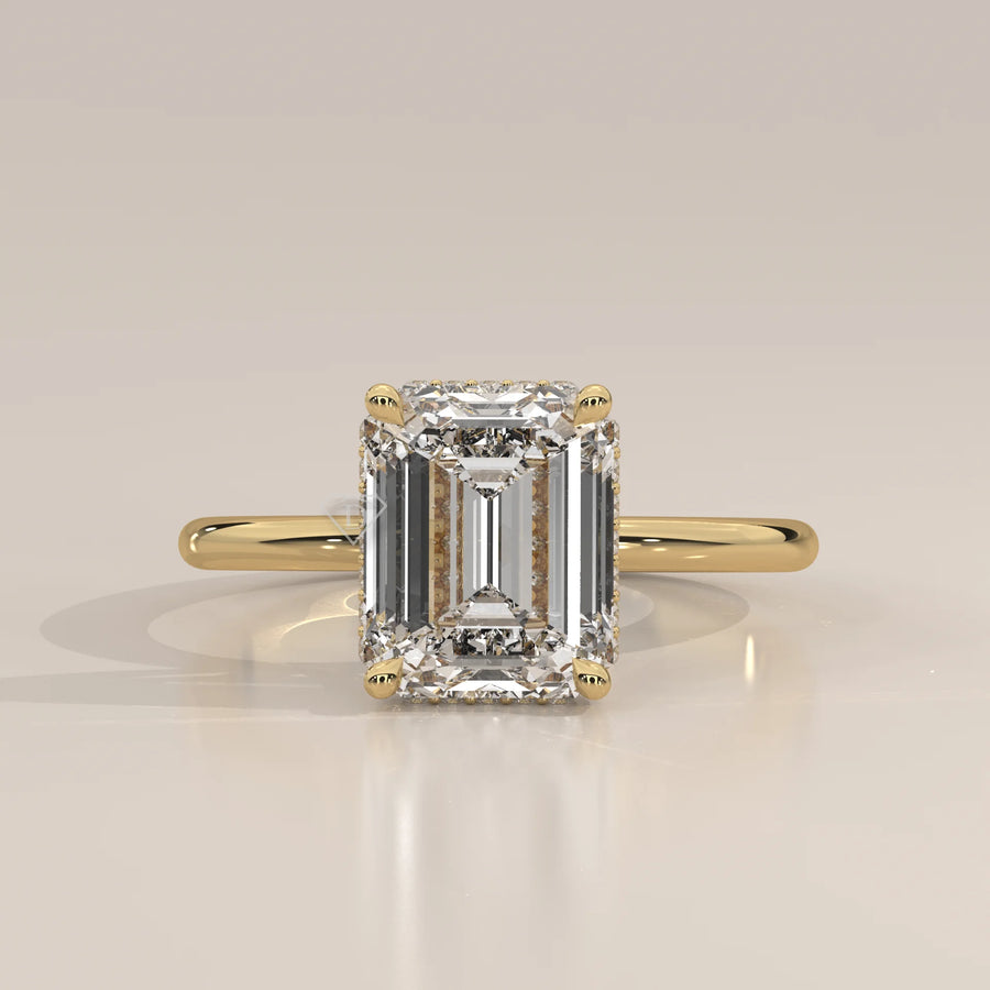 Emerald cut diamond engagement ring in yellow gold.
