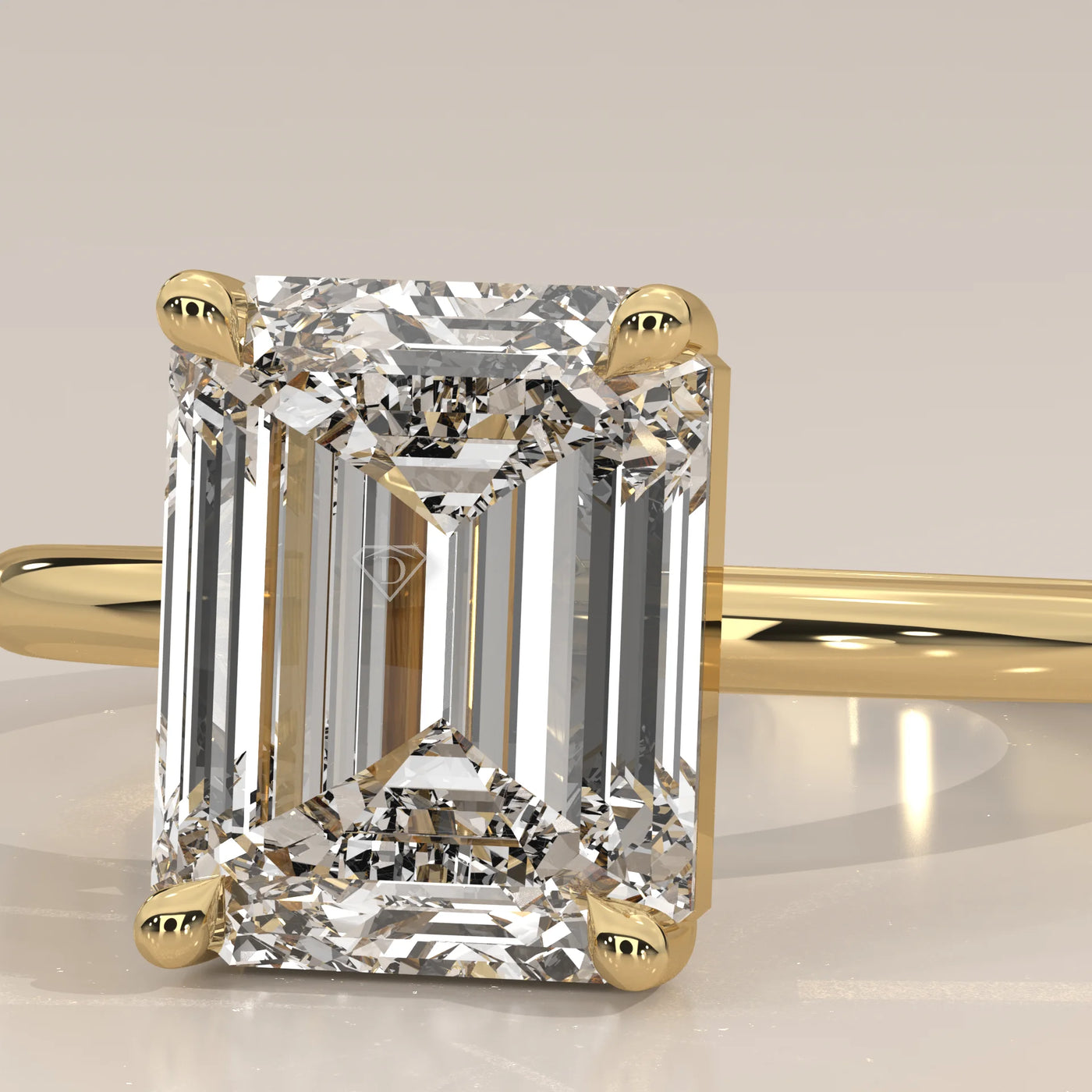 Emerald cut diamond ring with pavé band in yellow gold.