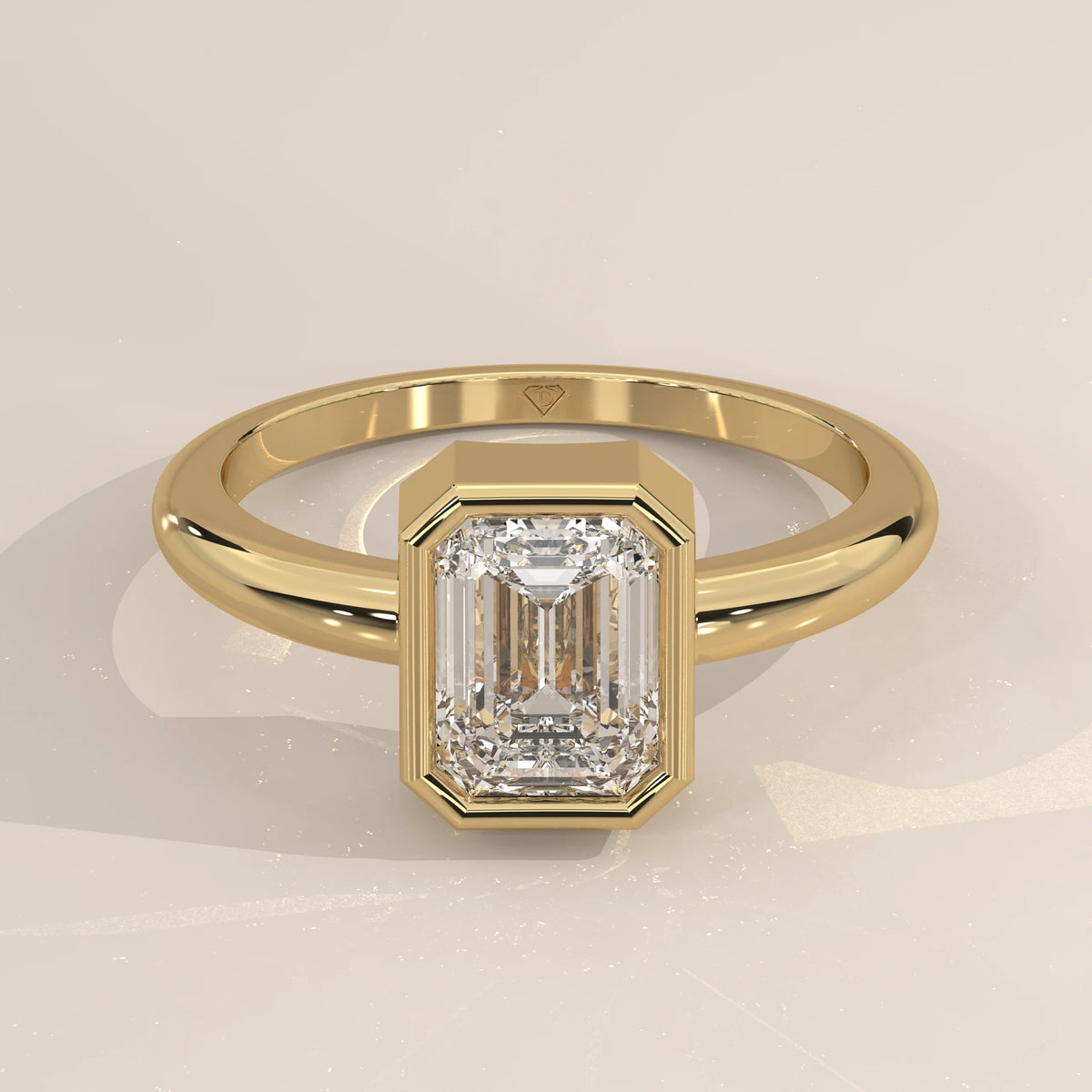 A stunning 18k yellow gold ring featuring a large emerald-cut diamond.