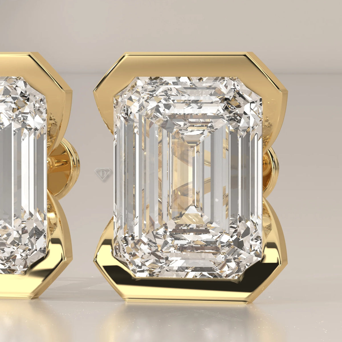 Emerald Cut Partial Bezel Lab Grown Diamond Stud Earrings in yellow gold, photographed head-on.