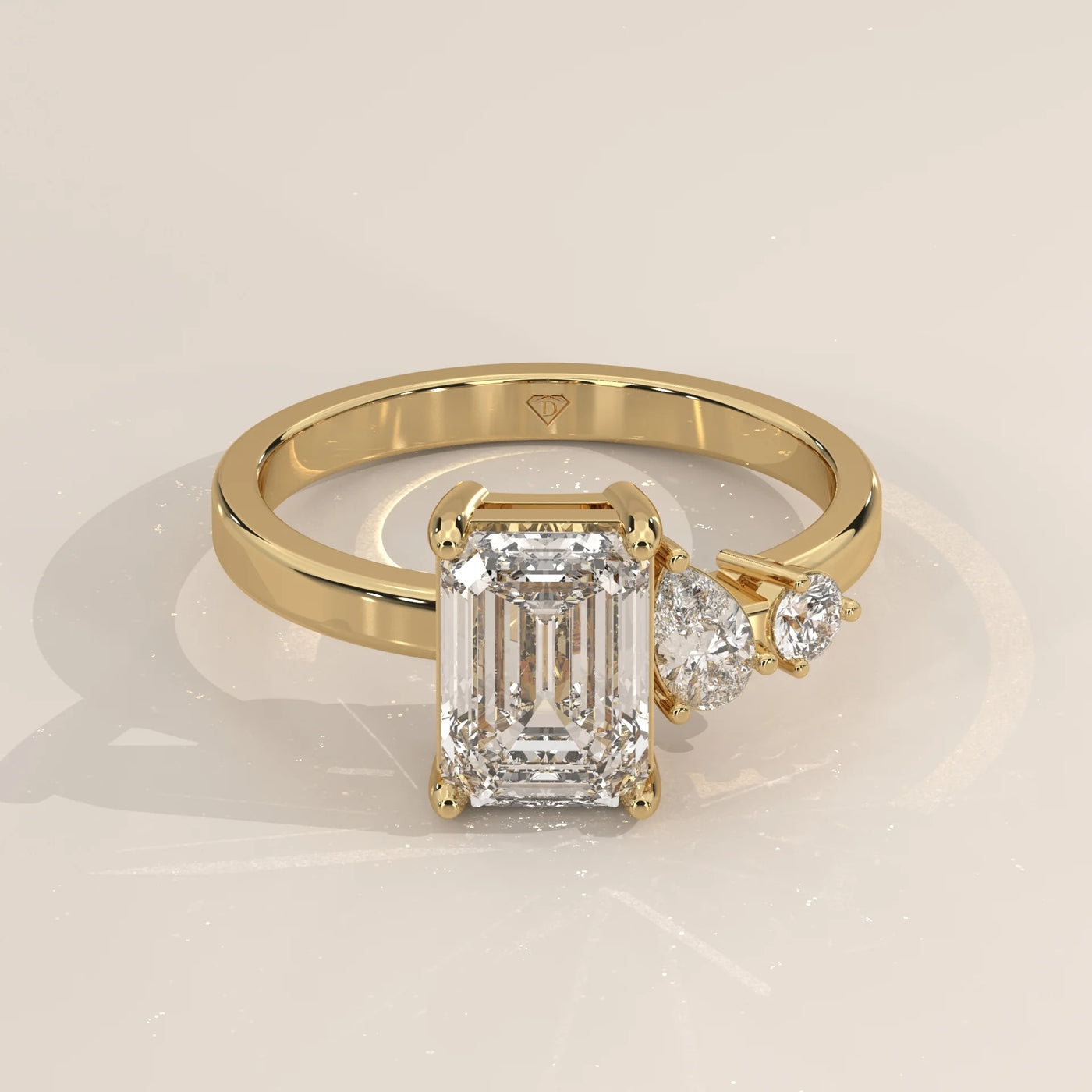 Three-Quarter View: Emerald Cut Diamond Ring with Three-Stone Setting in Yellow Gold – Lab Grown – Driona Jewels