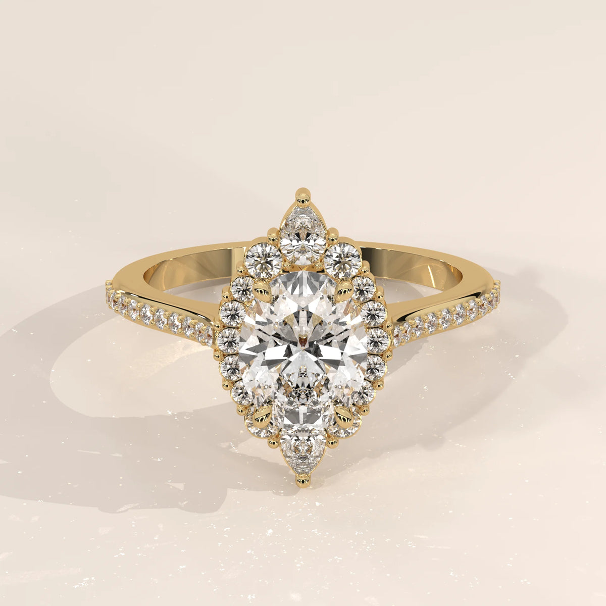 Elegant pear-shaped diamond halo engagement ring in yellow gold.