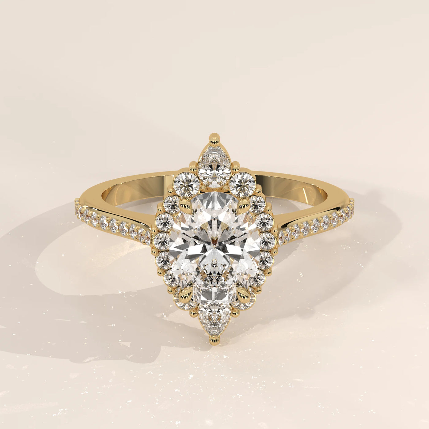 Elegant pear-shaped diamond halo engagement ring in yellow gold.