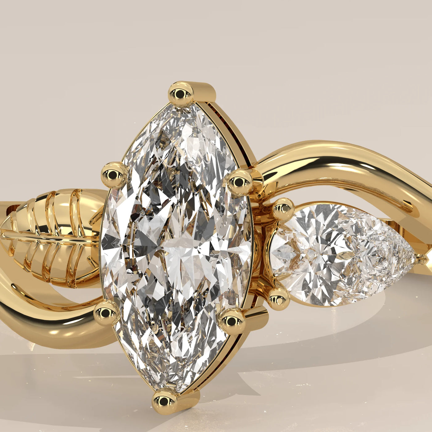 Yellow gold engagement ring featuring a marquise and pear-cut diamond.