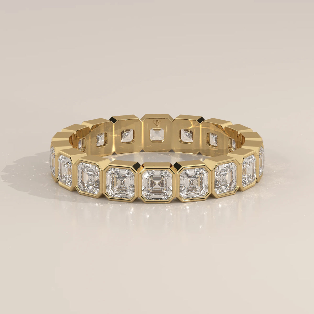 Square Emerald Cut Lab Grown Diamond Bezel Set Eternity Band in yellow gold, shown at an angle.
