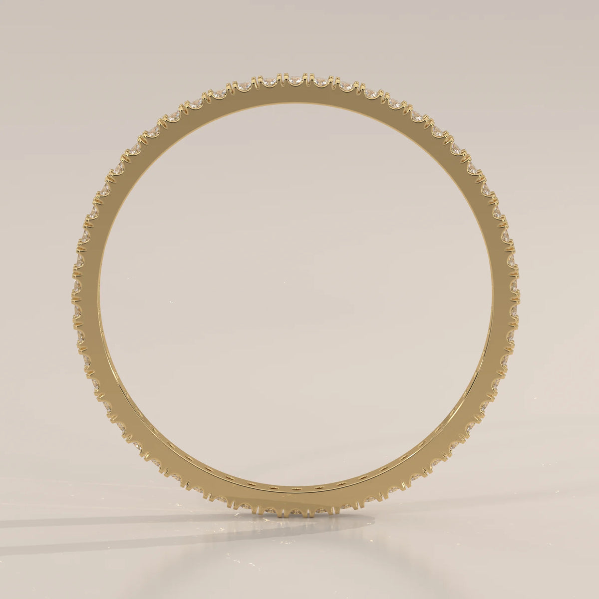 Yellow gold full eternity ring with bead set round lab grown diamonds and a scalloped edge, viewed from overhead.