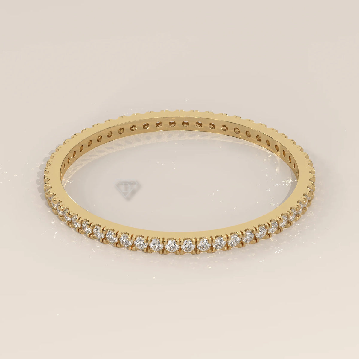 Yellow gold full eternity ring with bead set round lab grown diamonds and a scalloped edge, seen from above on a plain background.