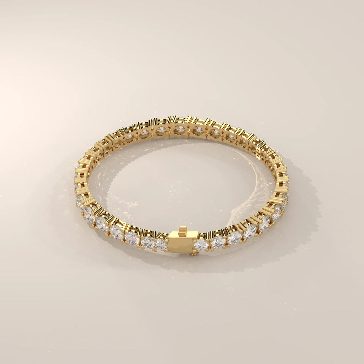 Graduated Round Lab Grown Diamond Tennis Bracelet, Four Prong in yellow gold, shown on a plain background.