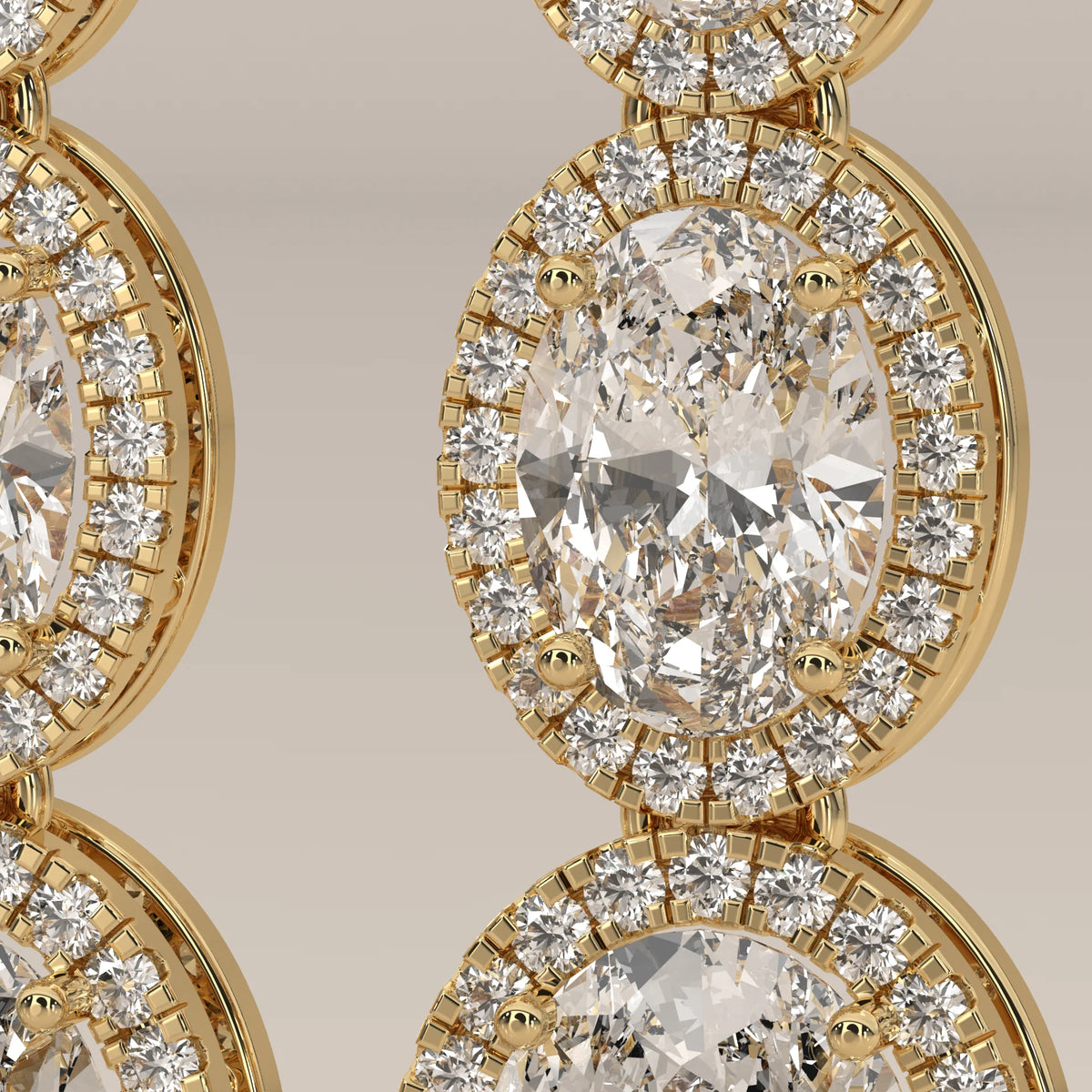 Graduated Three Oval Halo Lab Grown Diamond Drop Earrings in yellow gold, product photograph on a plain background.