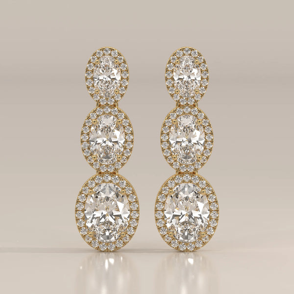 Graduated Three Oval Halo Lab Grown Diamond Drop Earrings in yellow gold, shown from the front.