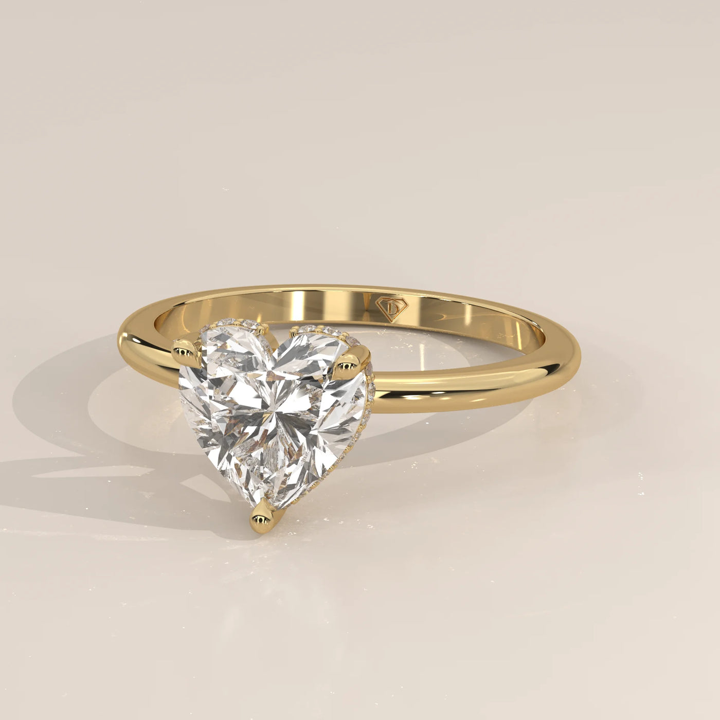 A beautiful 14k gold ring with a heart-shaped diamond and pave band.