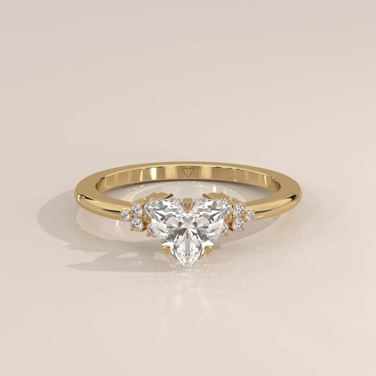 Gold ring with a heart-shaped diamond and smaller accent diamonds.