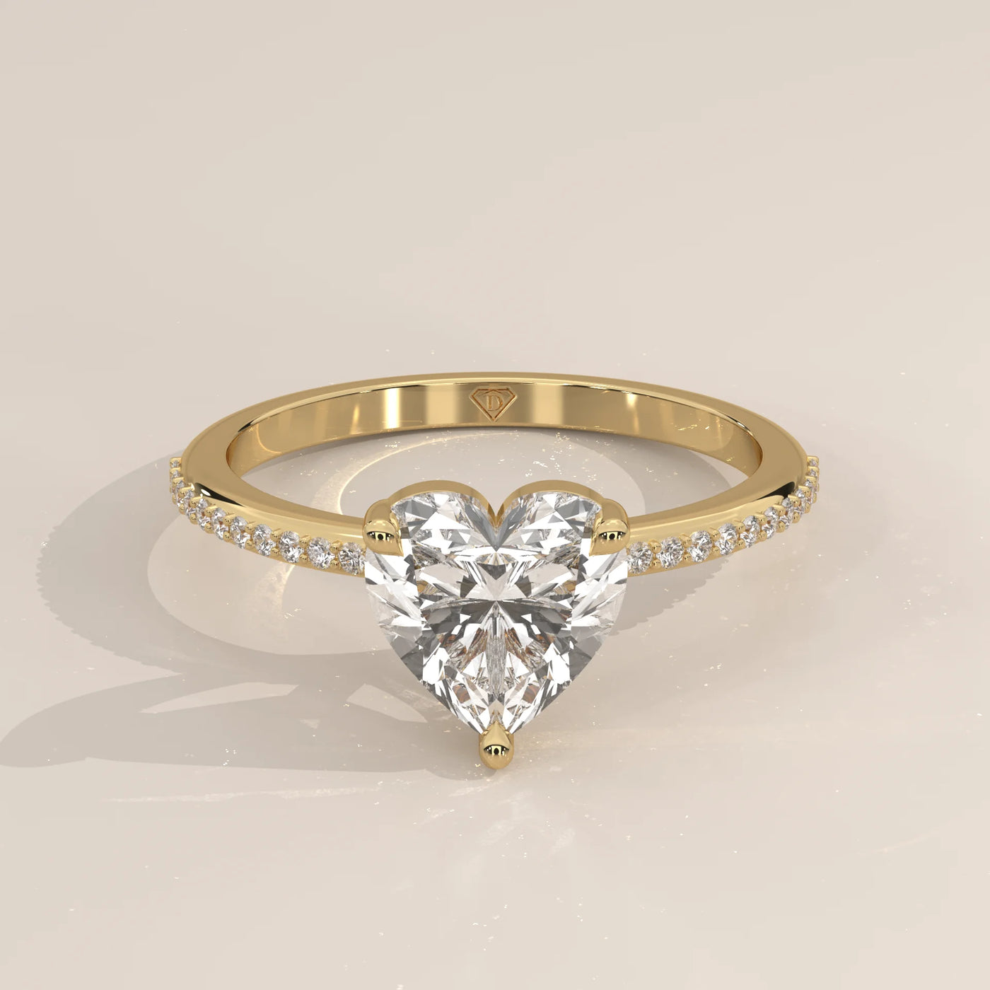 A beautiful 14k gold ring with a heart-shaped diamond and pave band.