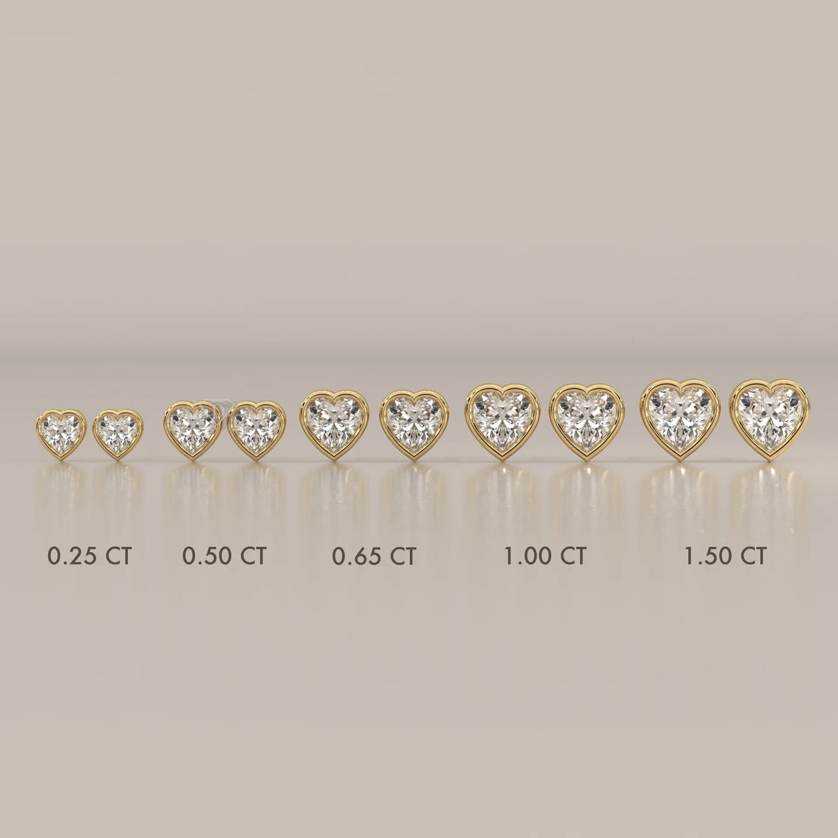 Several heart-shaped diamond earrings in gold settings of varying sizes.