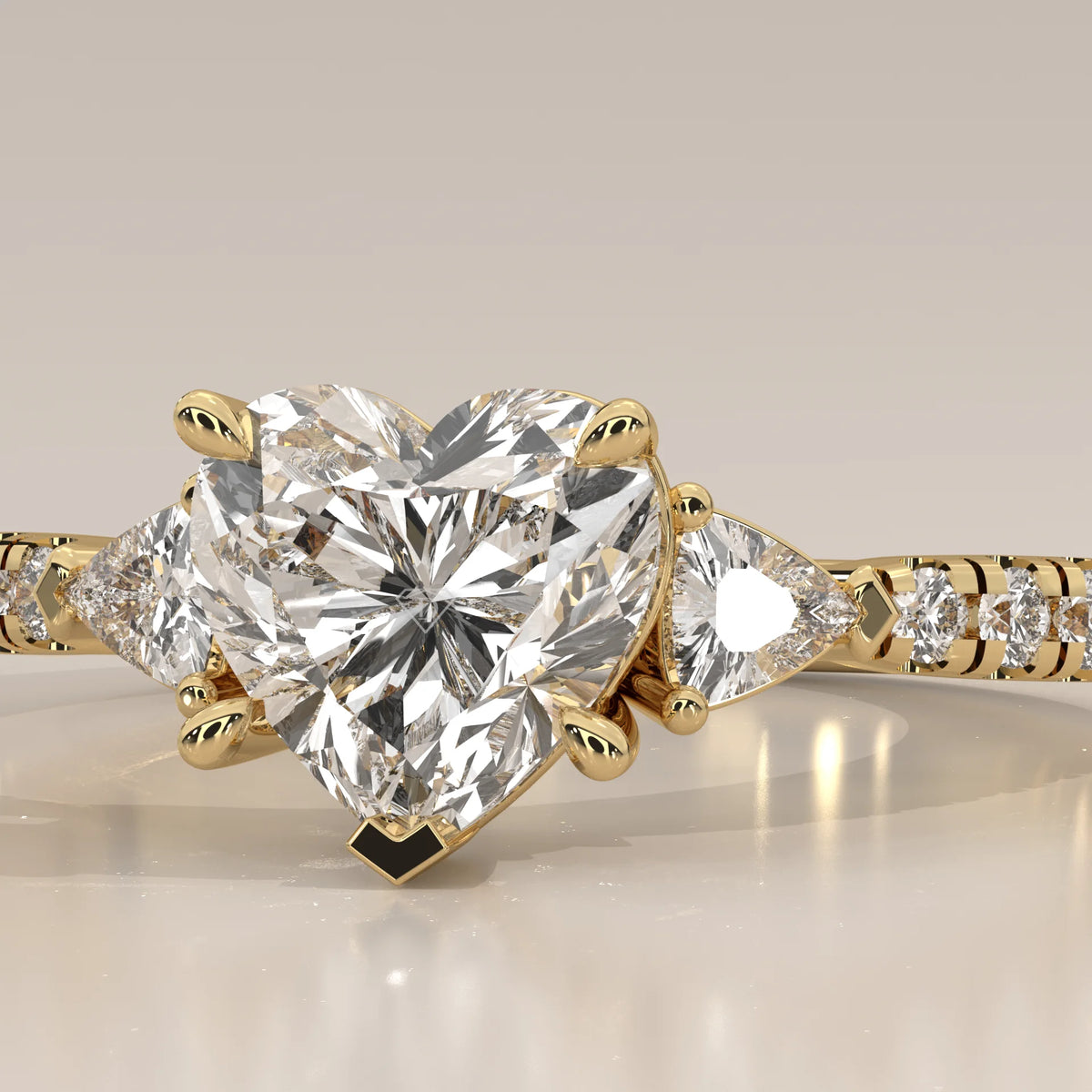 Heart Lab Grown Diamond Three Stone Ring with Trillion Sides in yellow gold, front view on a plain background.