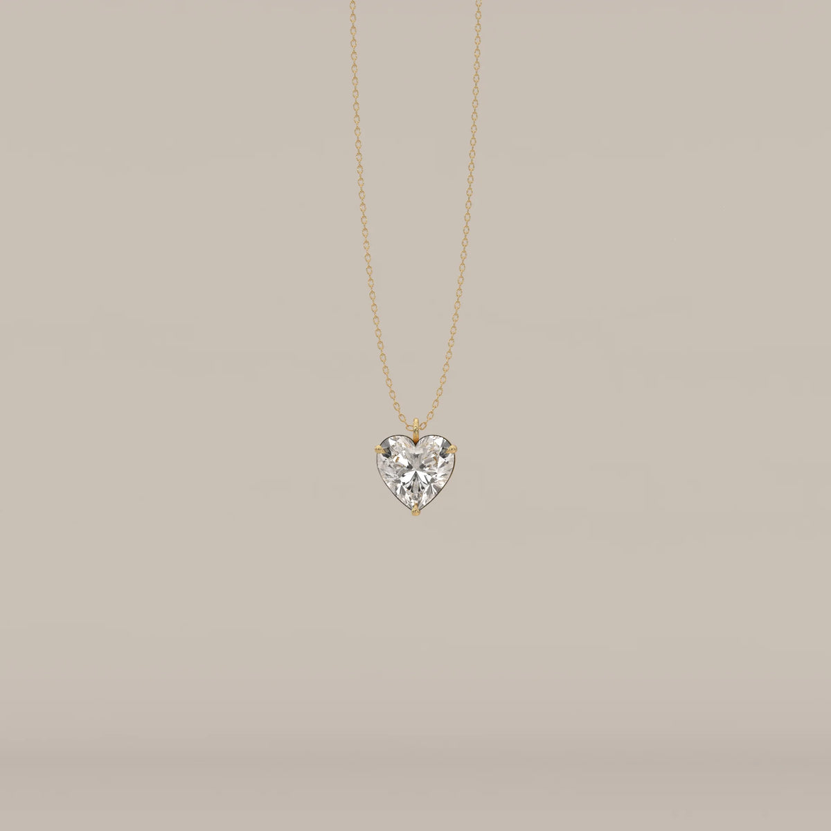 A delicate gold necklace with a sparkling heart-shaped diamond pendant.