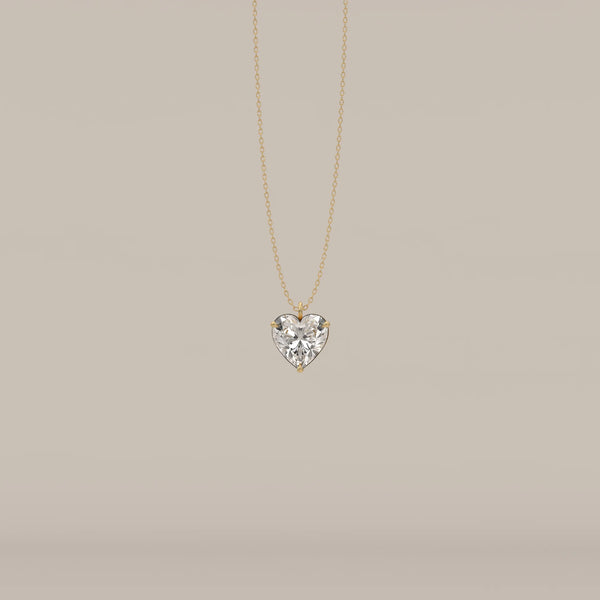 A delicate gold necklace with a sparkling heart-shaped diamond pendant.