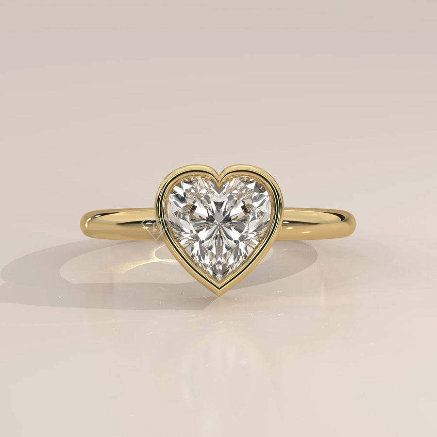 A beautiful 14k gold ring with a heart-shaped diamond and pave band.
